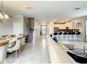 Open concept living area with a white couch, kitchen island, and dining table at 1670 Moon Valley Dr, Davenport, FL 33896