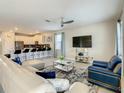 Spacious living room featuring a large sectional sofa and flat-screen TV at 1670 Moon Valley Dr, Davenport, FL 33896