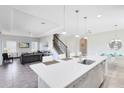 Modern kitchen with white cabinets, center island, and breakfast bar at 181 Brookes Pl, Haines City, FL 33844