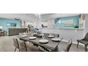 Open concept dining room with a large table and seating for six at 1840 Caribbean View Ter, Kissimmee, FL 34747