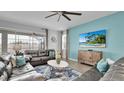 Living room with comfy seating, large TV, and view of the pool at 1840 Caribbean View Ter, Kissimmee, FL 34747