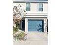 Front view of a townhome featuring a teal garage door at 2906 Fieldwood Cir, St Cloud, FL 34772