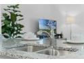 Modern kitchen featuring a stylish sink and granite countertops at 3331 Private Oak Dr, Apopka, FL 32703