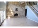 Living room with brick fireplace and hardwood floors at 772 Bear Creek Cir, Winter Springs, FL 32708