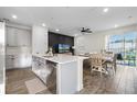 Open concept kitchen with island, stainless steel appliances, and dining area at 8135 Coconut Pl, Kissimmee, FL 34747