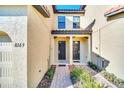 Two-story townhome with double front doors and paver walkway at 8169 Roseville Rd, Davenport, FL 33896