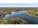 Aerial view showing a house near a lake and residential area at 117 Blue Heron Ct, Davenport, FL 33837