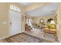 Bright entryway with a sitting area and decorative rug at 117 Blue Heron Ct, Davenport, FL 33837