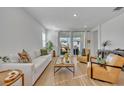 Bright living room with hardwood floors, comfortable seating, and large windows at 4473 Davos Dr, Clermont, FL 34711