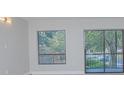 Living room featuring a sliding glass door and large window at 620 Cranes Way # 207, Altamonte Springs, FL 32701