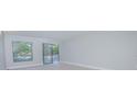 Living room with sliding glass doors leading to a balcony at 620 Cranes Way # 207, Altamonte Springs, FL 32701