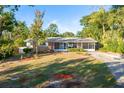 Brick ranch home with screened porch and landscaped yard at 2455 Waycross Ave, Eustis, FL 32726