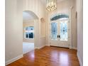 Bright entryway with hardwood floors and arched doorways at 3277 Lakeview Oaks Dr, Longwood, FL 32779