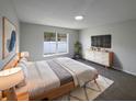 Main bedroom with a large bed, dresser, and a wall-mounted TV at 7 Bolton Ct, Kissimmee, FL 34758