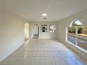 Bright and airy living room with tile floors and access to the kitchen at 7 Bolton Ct, Kissimmee, FL 34758