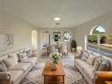 Spacious living room with light beige couches and a large window at 7 Bolton Ct, Kissimmee, FL 34758