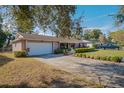 House exterior showcasing a driveway and landscaping at 7022 Talbot Dr, Orlando, FL 32819