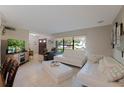 Bright living room featuring white couches and a large TV at 7022 Talbot Dr, Orlando, FL 32819