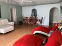 Bright dining area with hardwood floors and a wooden table at 209 Curtis Ave, Groveland, FL 34736