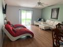 Spacious living room with hardwood floors and comfortable seating at 209 Curtis Ave, Groveland, FL 34736