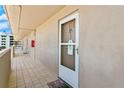 Exterior hallway with tiled floors leading to condo entry at 4155 S Atlantic Ave # 210, New Smyrna Beach, FL 32169