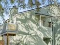 Two-story building with balconies, trees, and stairs at 5865 La Costa Dr # 216, Orlando, FL 32807