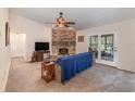 Living room features a brick fireplace and sliding glass doors leading to a patio at 6316 Autumn Chase Ln, Orlando, FL 32818