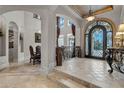 Spacious entryway with high ceilings, elegant staircase, and ornate iron door at 9301 Tibet Pointe Cir, Windermere, FL 34786