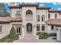 Elegant home with arched entryway, balcony, and Mediterranean-style architecture at 9301 Tibet Pointe Cir, Windermere, FL 34786