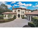 Two-story house featuring a grand entrance and brick paver driveway at 9301 Tibet Pointe Cir, Windermere, FL 34786
