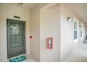 Condo building entry with private door and fire extinguisher at 9447 Myrtle Creek Ln # 113, Orlando, FL 32832