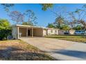 Front view of a ranch style home with carport at 1921 Rockwell Rd, Orlando, FL 32808