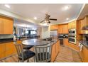 Open concept kitchen with breakfast bar and hardwood floors at 1925 S Atlantic Ave # 502, Daytona Beach, FL 32118
