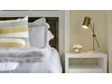 Bright bedroom with white nightstand, lamp, and plush bedding at 2125 Pigeon Plum Dr, Haines City, FL 33844