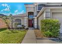 Front entrance with a walkway and landscaping at 1096 Ballyshannon Pkwy, Orlando, FL 32828