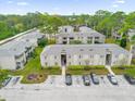 Aerial view of a condo complex with parking, landscaping, and surrounding trees at 113 Springwood Cir # D, Longwood, FL 32750