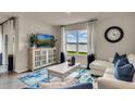Living area features a white couch, coffee table, and a view of the backyard at 2952 Waterlily Way, Poinciana, FL 34759