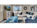 Living room features a white sectional sofa, a coffee table and large window at 2952 Waterlily Way, Poinciana, FL 34759