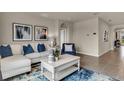 Spacious living room with an L-shaped sofa and a coffee table at 2952 Waterlily Way, Poinciana, FL 34759