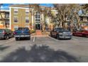 Building exterior showcasing parking and landscaping at 3997 Versailles Dr # 3997F, Orlando, FL 32808