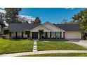 Inviting home exterior with a double-door entry and landscaped front yard at 504 Birdsong Ct, Longwood, FL 32779