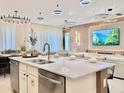 Open-concept kitchen with a large island, modern appliances, and dining area at 6234 Sand Skipper Rd, Orlando, FL 32821