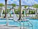 Resort-style pool with a chairlift, lounge chairs, and palm trees at 6234 Sand Skipper Rd, Orlando, FL 32821