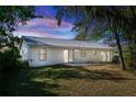 Home's rear view, showcasing a patio and grassy yard at 1073 Humphrey Blvd, Deltona, FL 32738