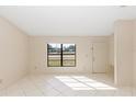 Bright living room with tile floors and large window at 1073 Humphrey Blvd, Deltona, FL 32738