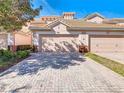 Two-story townhome with attached garage and paved driveway at 1300 Gilford Point Ln # 1300, Davenport, FL 33896