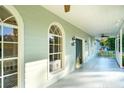 Inviting front porch with white railings, arched windows, and a dark green front door at 4942 Simmons Rd, Orlando, FL 32812