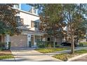 Townhome community featuring a two-story building with garage and driveway at 659 Fortanini Cir, Ocoee, FL 34761