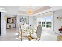Elegant dining room with glass table and gold chairs at 7593 Gathering Dr # 802, Reunion, FL 34747