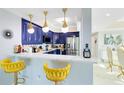 Stylish kitchen with blue cabinets and breakfast bar at 7593 Gathering Dr # 802, Reunion, FL 34747